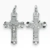 Dos colgantes de cruz de filigrana en plata de ley 925, uno con la figura de Cristo crucificado y otro con diseño calado sin Cristo.
