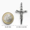 Dimensiones de 23 mm por 44 mm de la cruz de calvario de plata junto a una moneda de un euro.